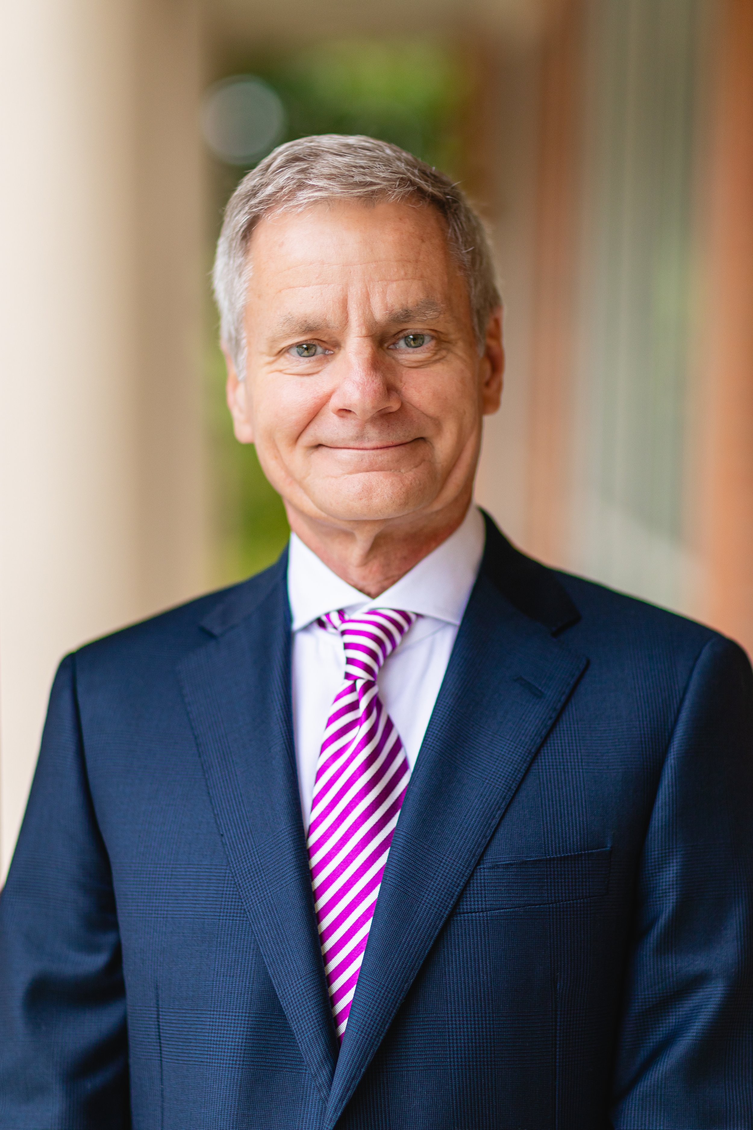 A financial advisor smiling for a headshot portrait during a commercial headshot portrait session in Tampa, FL.