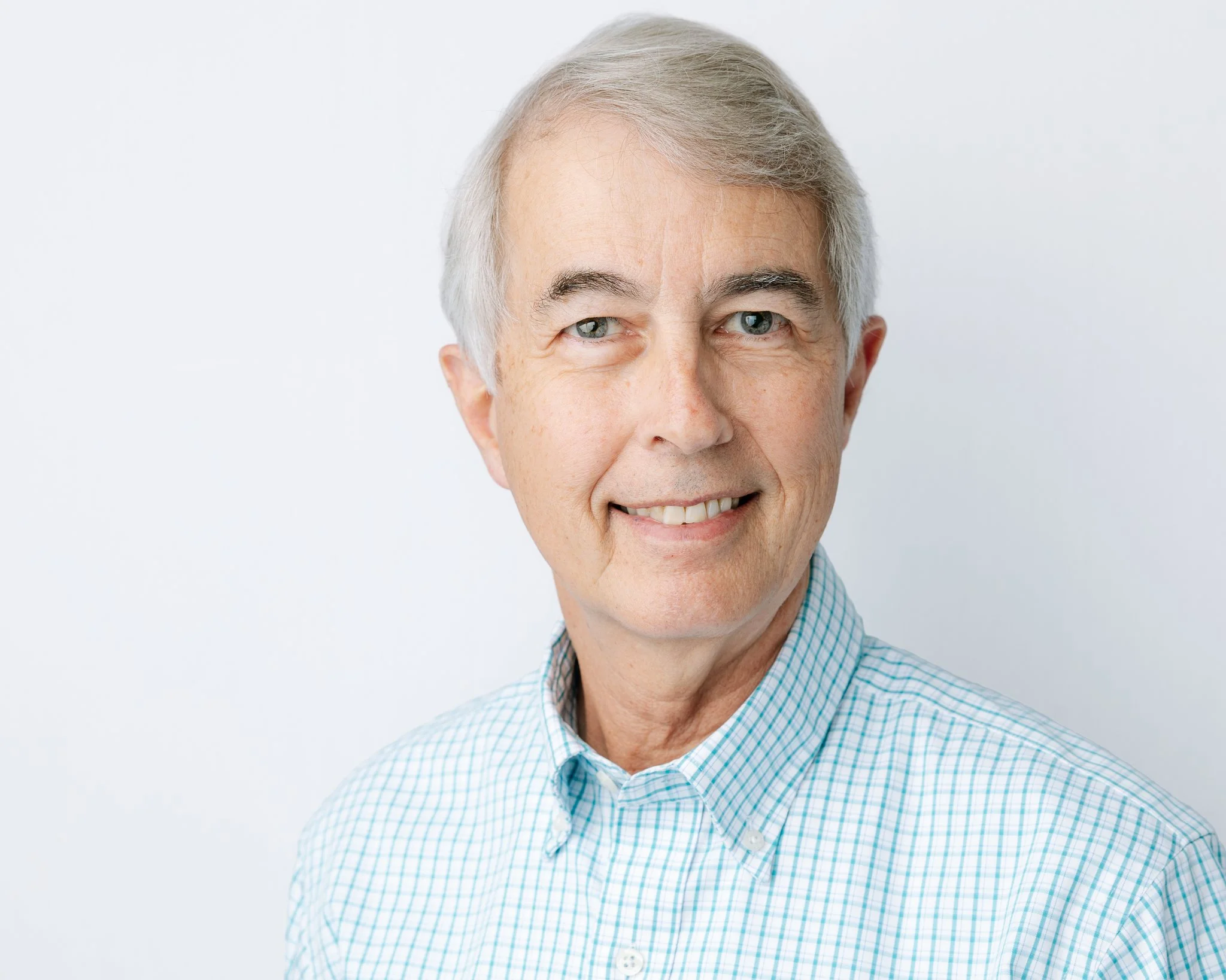 An orthodontist smiling for a headshot portrait during a commercial headshot portrait session in Tampa, FL.