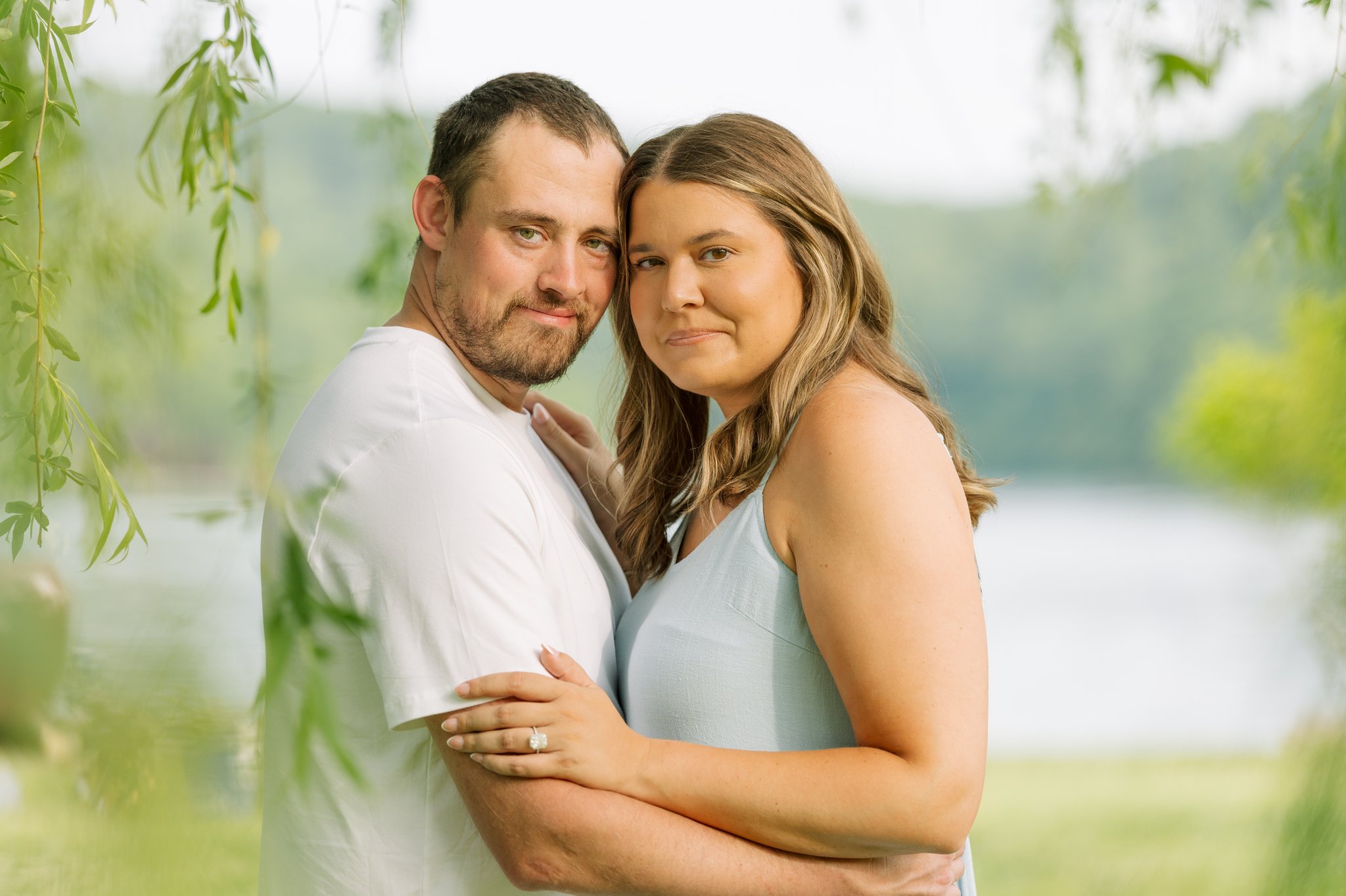A couple embracing, smiling, for a Tampa, FL engagement photo session.