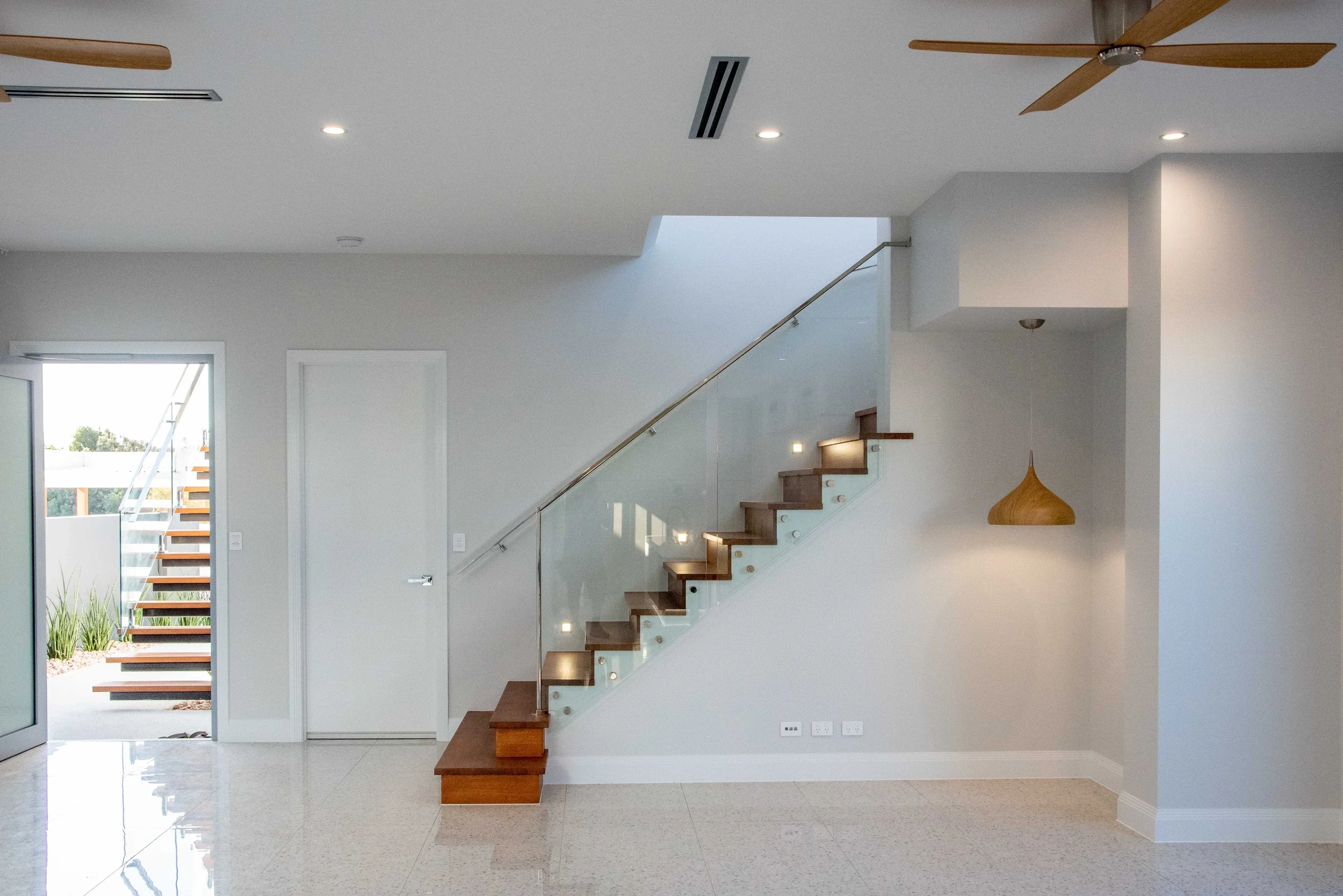 cylinders-66-kingscliff-07-entry-and-glass-staircase.webp