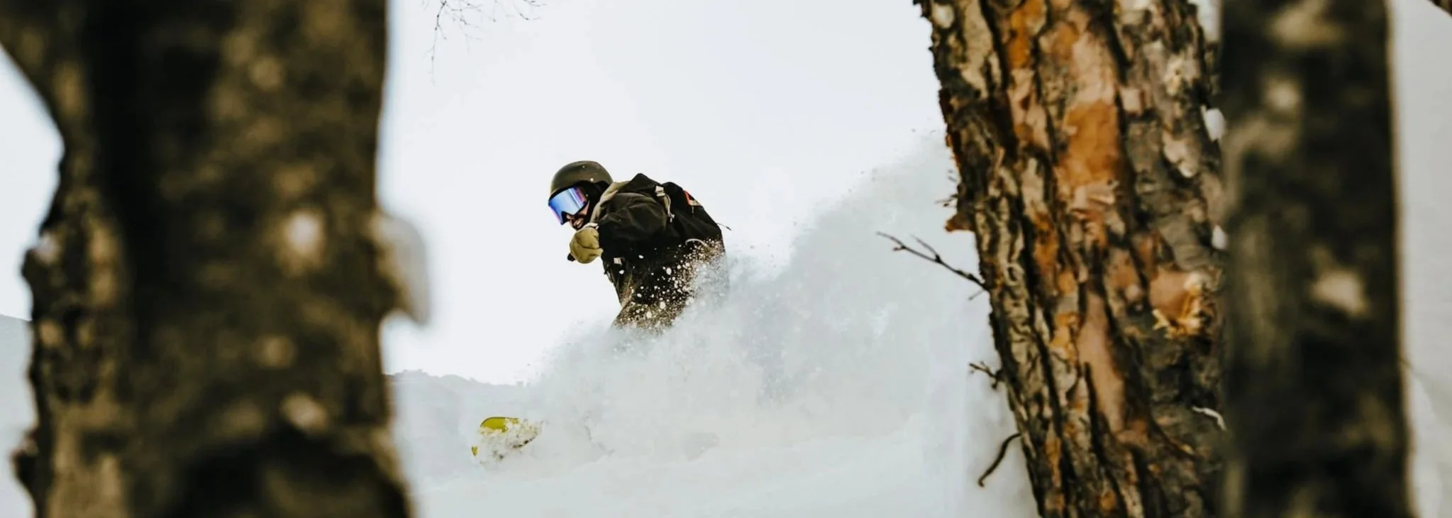 Snowboarder riding deep powder snow during a guided lesson in Niseko and Kiroro