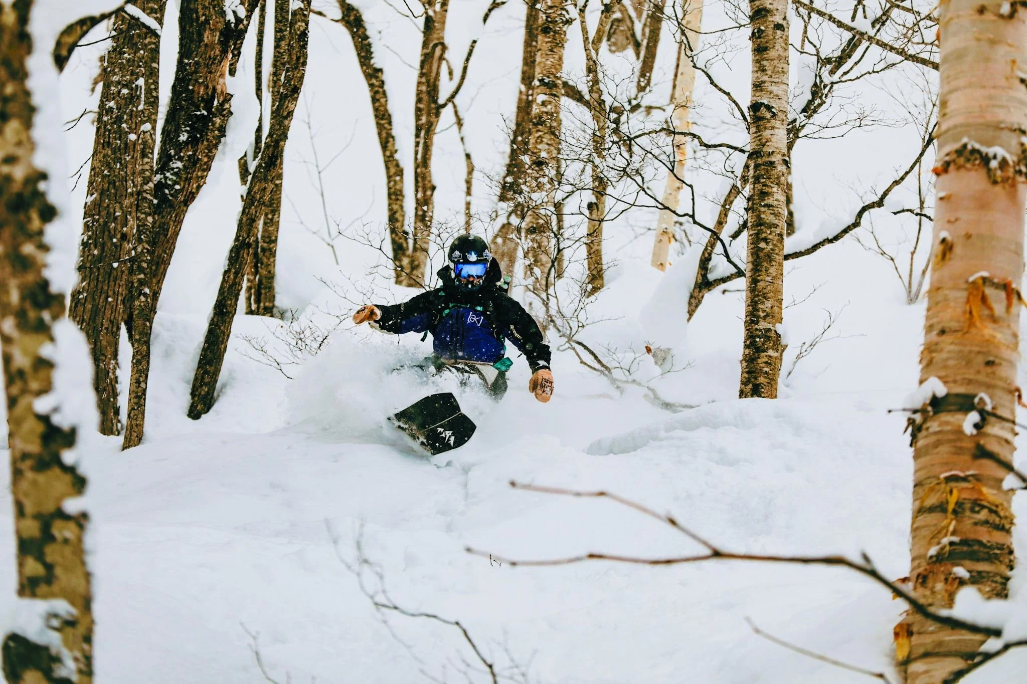 Snowboarder improving powder riding skills during a private lesson in Niseko.