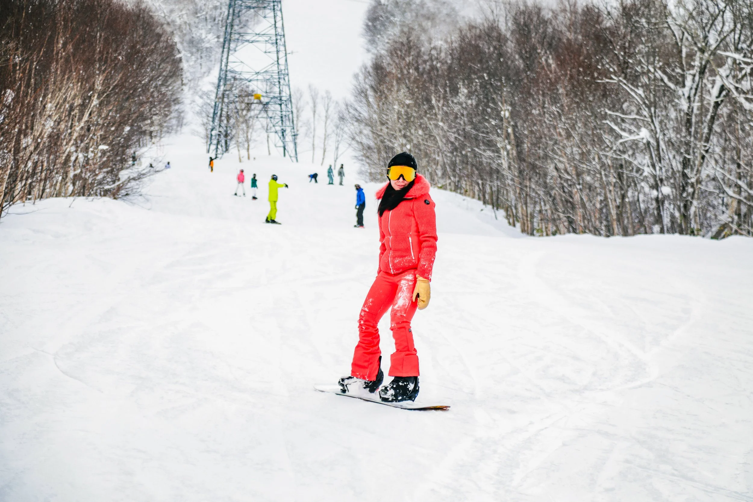 Beginner snowboard lesson on groomed terrain in Rusutsu, Japan.