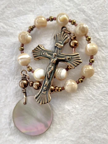 Chaplet handmade of natural mother of pearl, brass, and bronze, by Still Stone and Moss Prayer Bead Art, detail view.