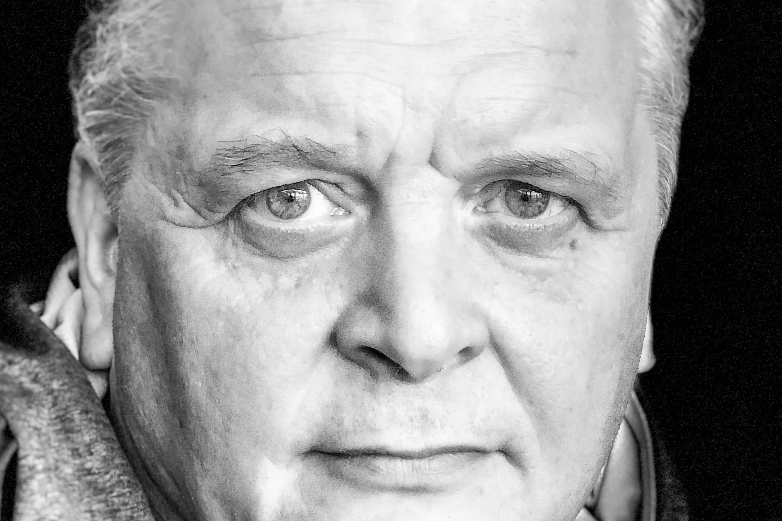 Black-and-white portrait of Paul Roebuck looking directly at the camera