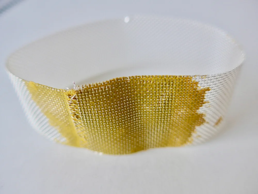 Sugru was pressed into copper mesh to colour and join the material. It was then silver plated. I haven’t made any finished pieces yet which have been plated, but have applied sugru to silver plated necklaces click here to see an example