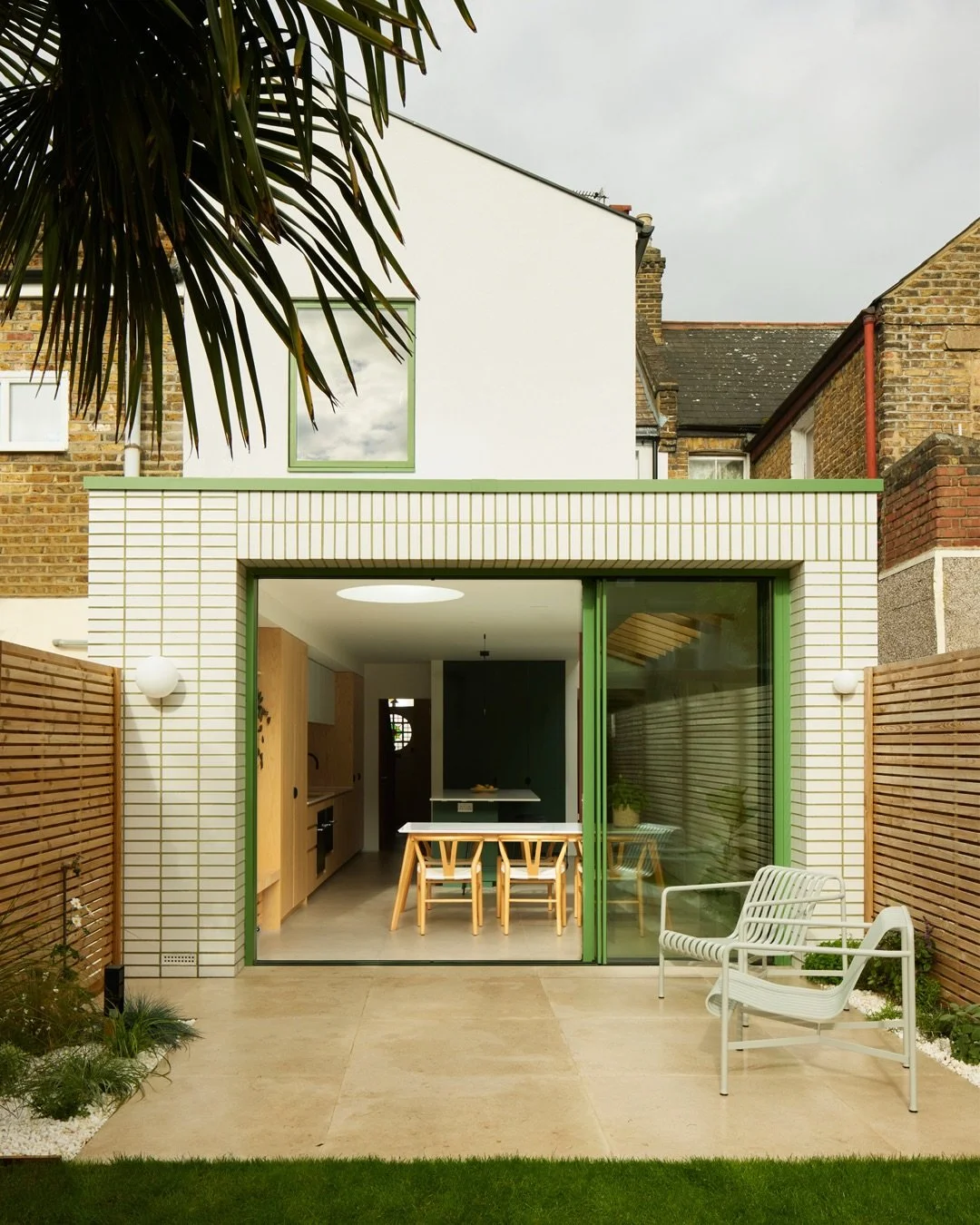 The Glazed Brick Extension was inspired by a studio field trip to Antwerp in Belgium. Here, we fell in love with a new passive housing development constructed in a geometric array of stacked white glazed bricks with green mortar. A new project had la