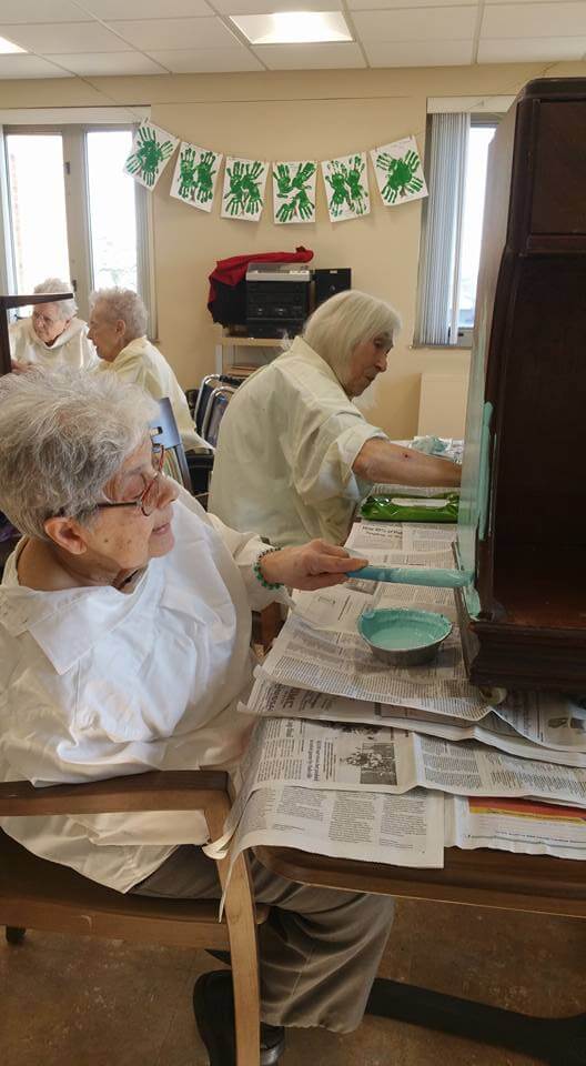 Residents enjoying painting furniture class at St. Louis Altenheim.
