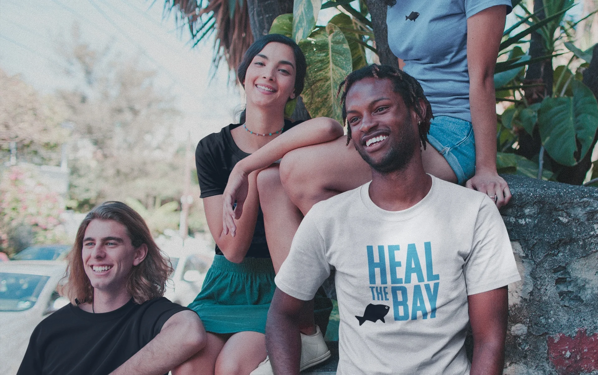 interracial-group-of-four-friends-living-the-van-life-wearing-t-shirts-mockup-under-plants-a20110.jpg