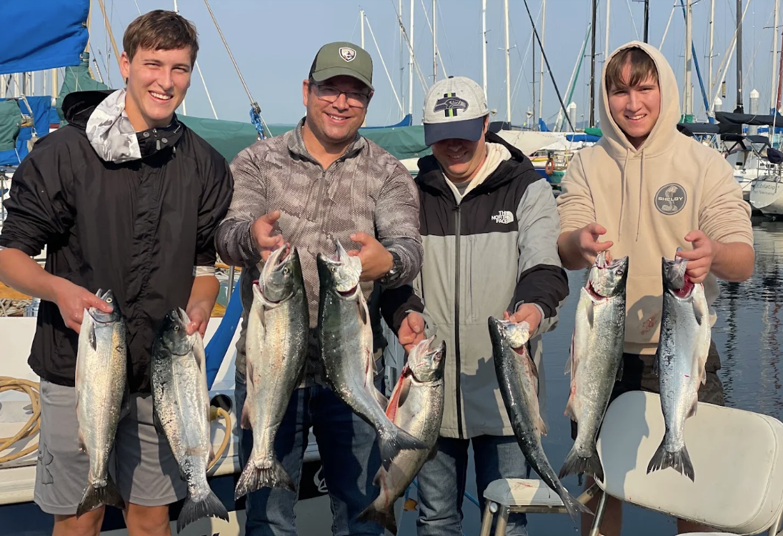 4 anglers with a limit of coho salmon with wind knot guides on puget sound near seattle
