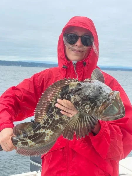 women posing with a lingcod caught on www.salmonseattle.com lingcod fishing charter