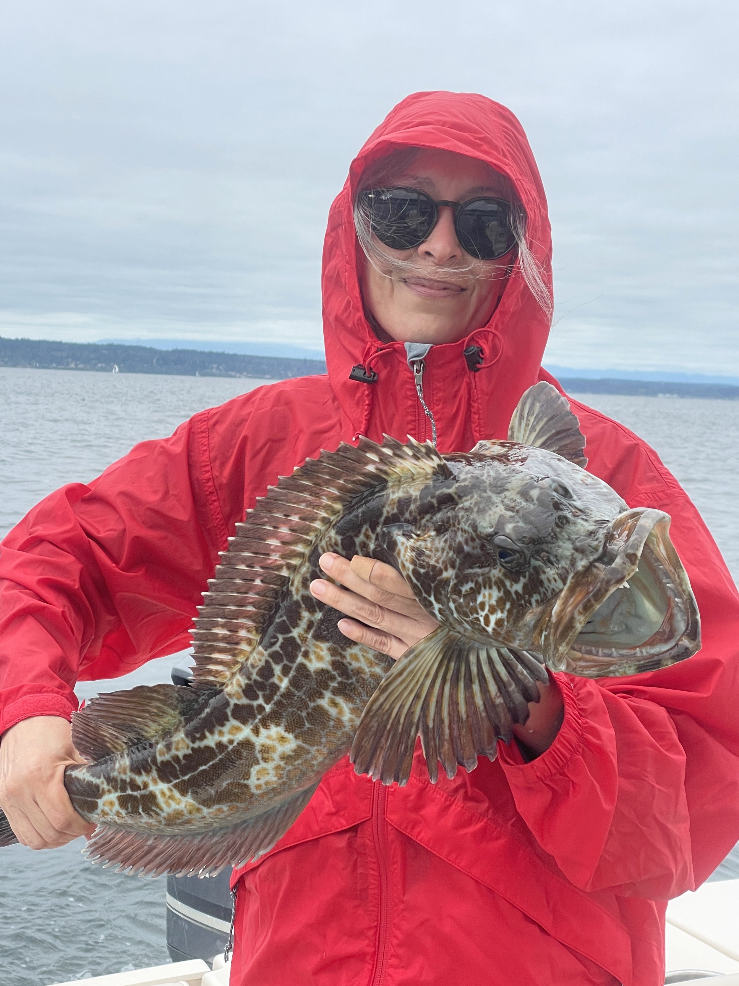 women posing with a lingcod caught on www.salmonseattle.com lingcod fishing charter