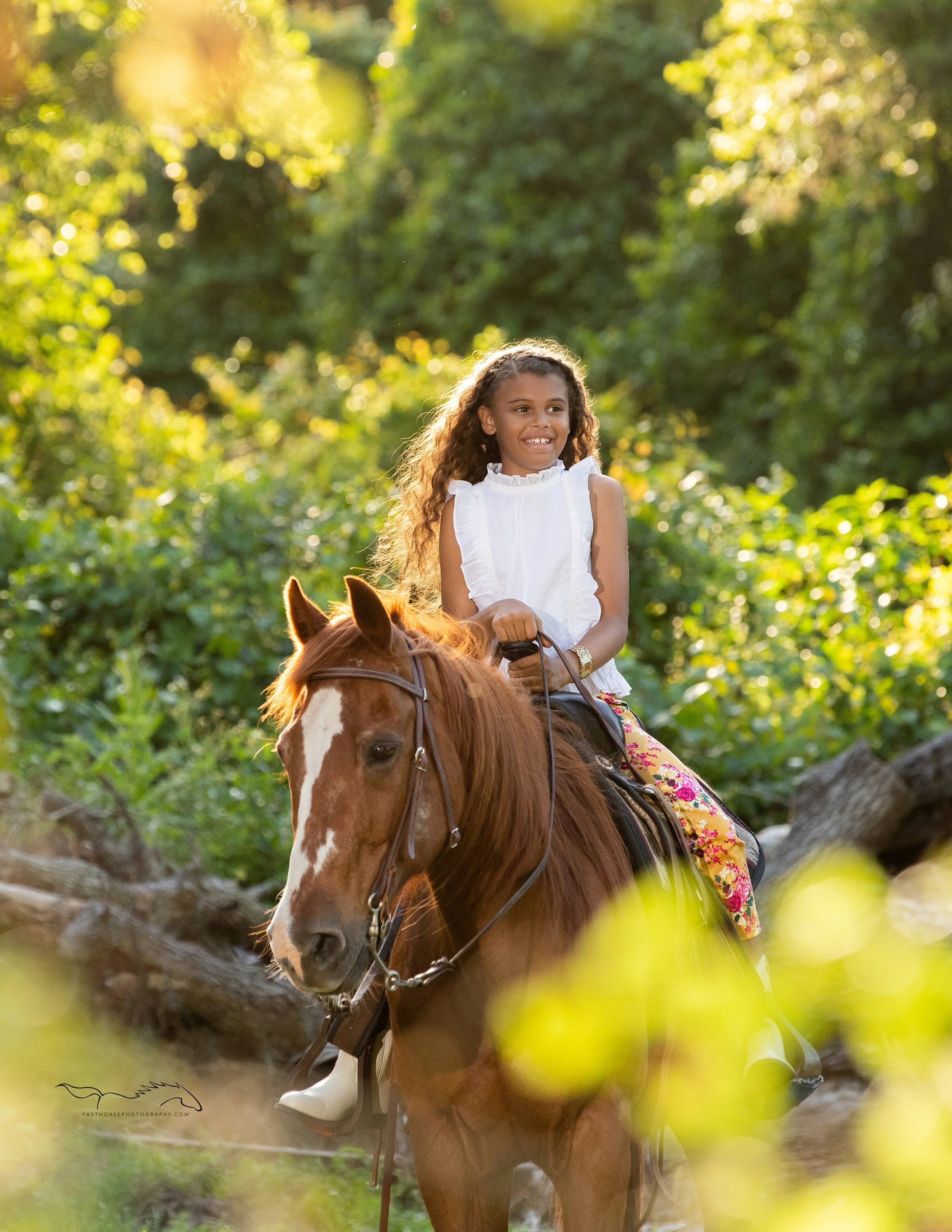 tween girl sits on her horse and smiles