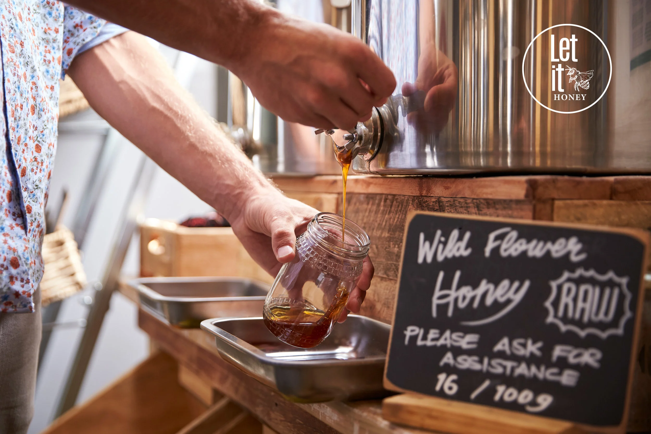 man-filling-container-with-wild-honey-in-68KCADM.jpg