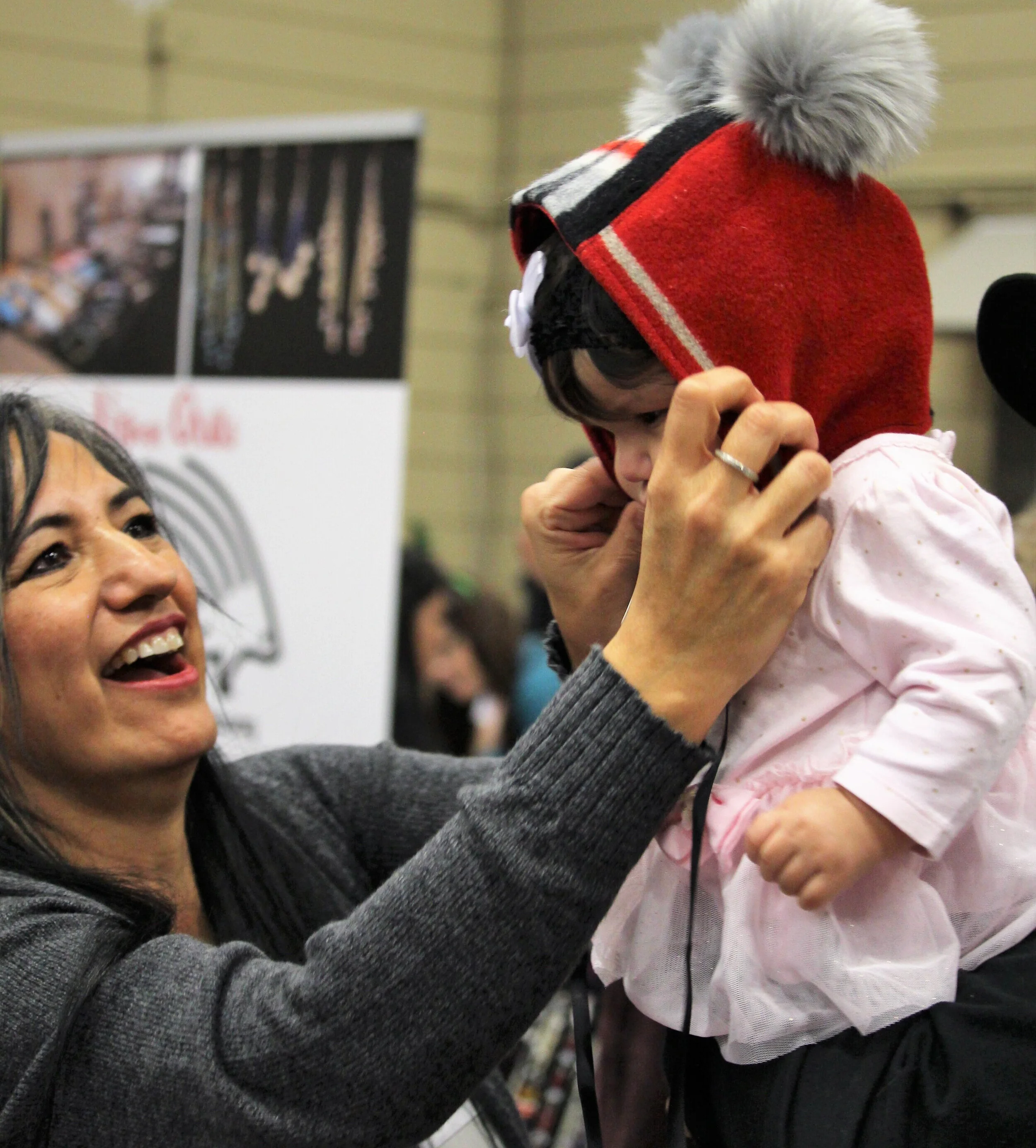 Shoppers try on the many unique handmade items available! (Photo by Lance Cardinal)