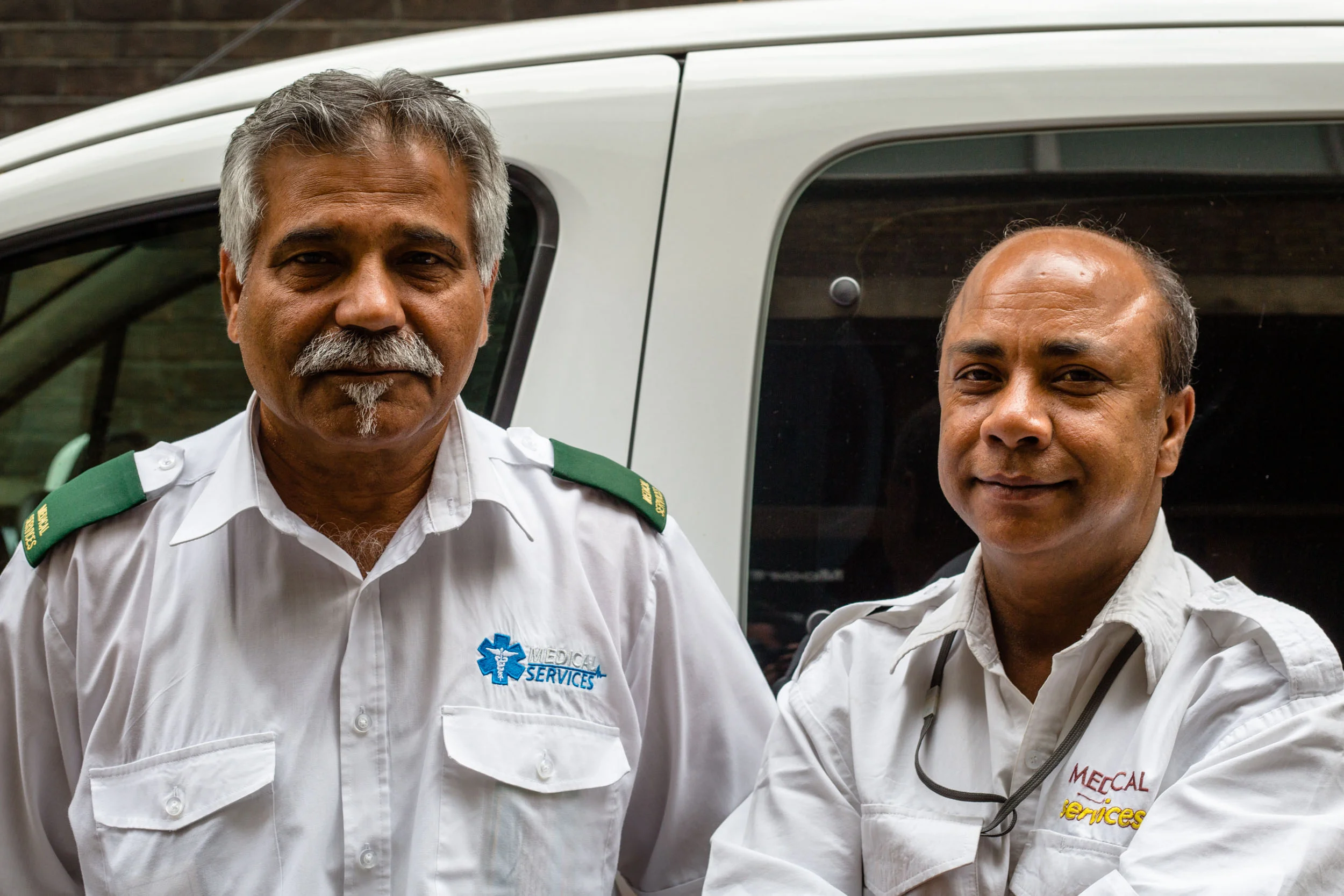 Khan and Islam, Patient Transporters. London 2016. From my series on the staff and patients of Moorfields Eye Hospital, ‘ The Dark Green Line ’