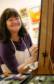 Kathy at her easel in her studio