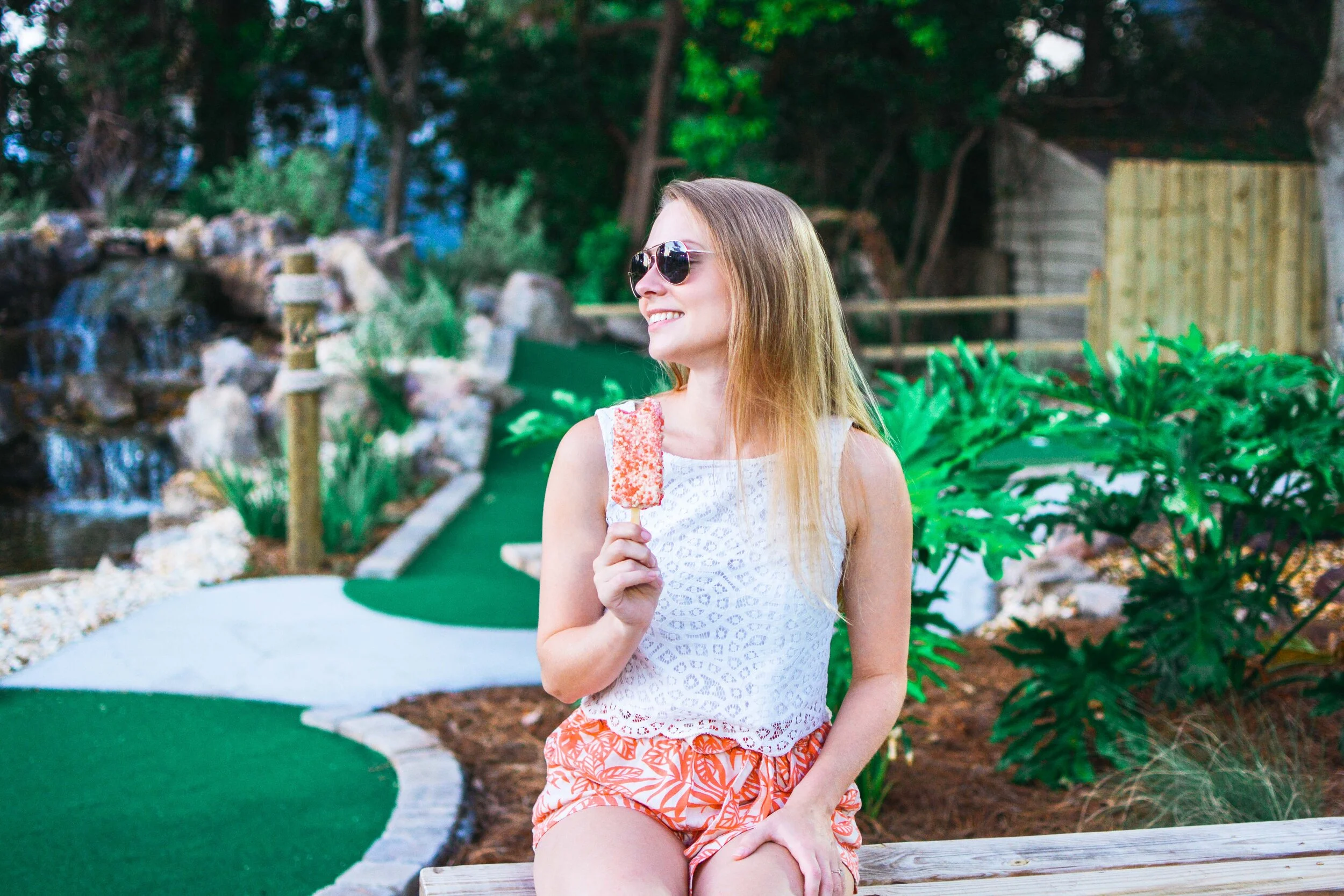 Woman eating ice cream on the mini golf course