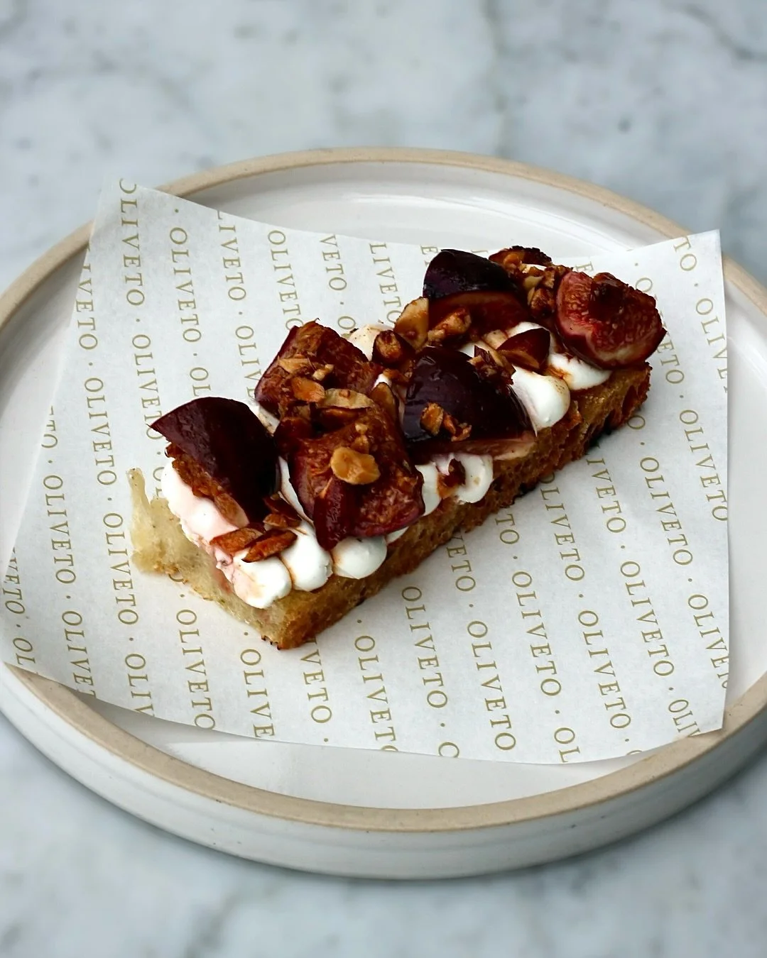 BRUSCHETTA // Bruschetta of whipped goats cheese, figs, honey, smoked almond&mdash;enjoy in Oliveto as part of our &agrave; la carte menu.