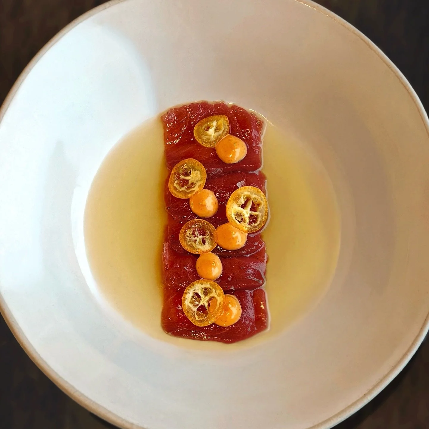 TUNA CRUDO // Tuna crudo on roasted sweet pepper, with citrus aioli and kumquat. This stunning small plate is available on our evening &agrave; la carte menu.
