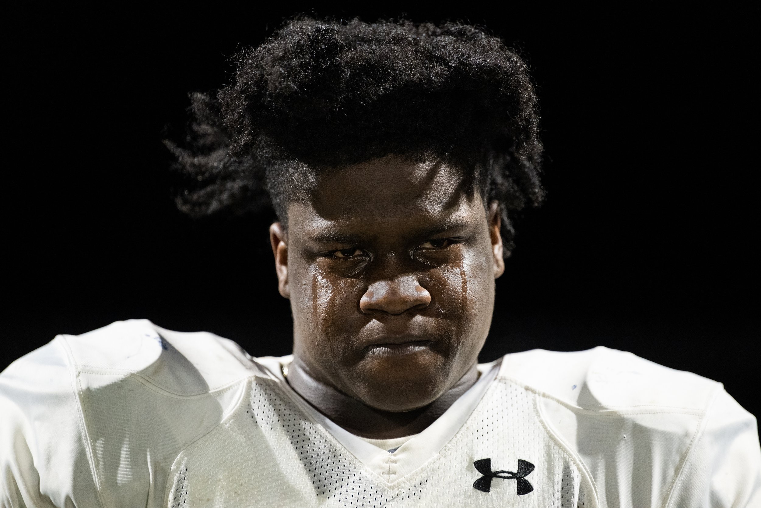  Corcoran senior fullback Juelz Martin sheds tears after West Genesee scores the last touchdown in the final minutes of the game. The game ends with West Genesee defeating Corcoran, 19-7, to take the third seed in the post-season. The Cougars will no