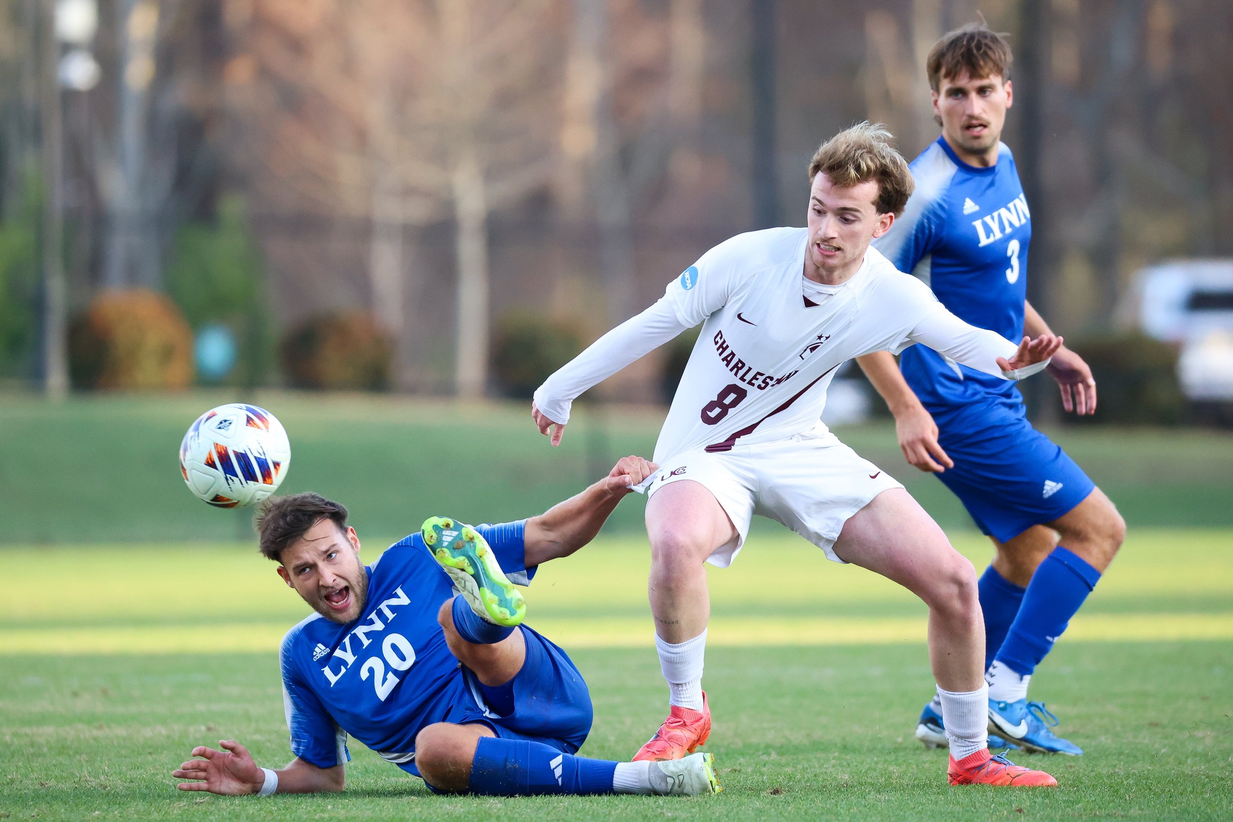  MATTHEWS, NORTH CAROLINA - DECEMBER 14: Jan Rohrling #20 of the Lynn Fighting Knights and Caio Moraes #8 of the Charleston Golden Eagles compete for the ball during the second half during the Division II Men’s Soccer Championship held at Sportsplex 