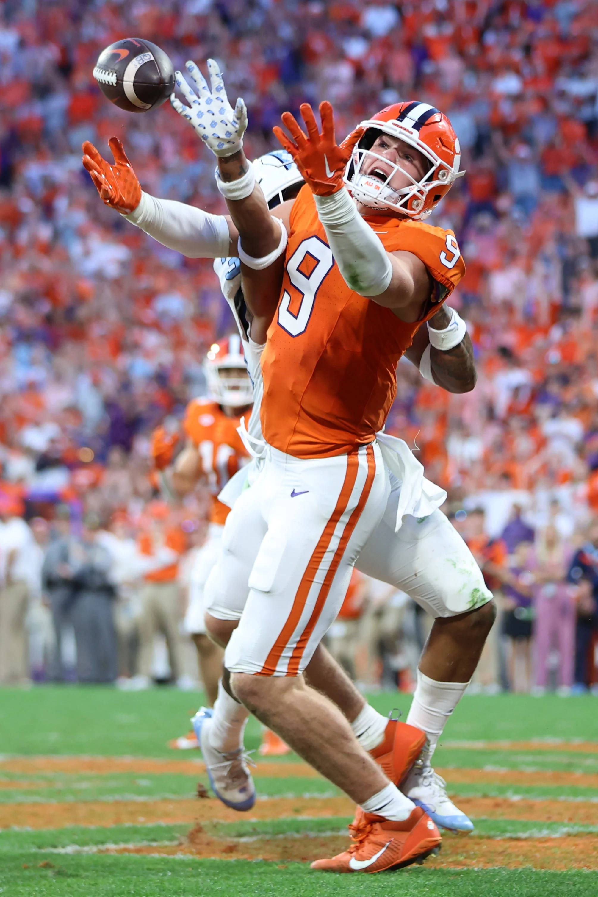  CLEMSON, SOUTH CAROLINA - NOVEMBER 18: Jake Briningstool #9 of the Clemson Tigers reaches for a catch against Cedric Gray #33 of the North Carolina Tar Heels at Memorial Stadium on November 18, 2023 in Clemson, South Carolina. (Photo by Isaiah Vazqu