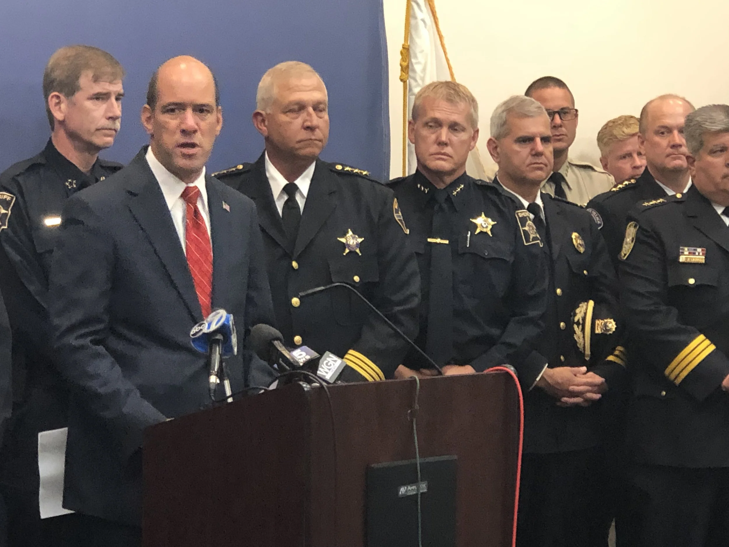 DuPage County State’s Attorney Bob Berlin, flanked by DuPage County law enforcement officials, announces the creation of the Metropolitan Emergency Response and Investigative Team.