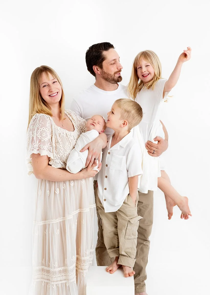 newborn-family-standing-playful-white-studio-victoria