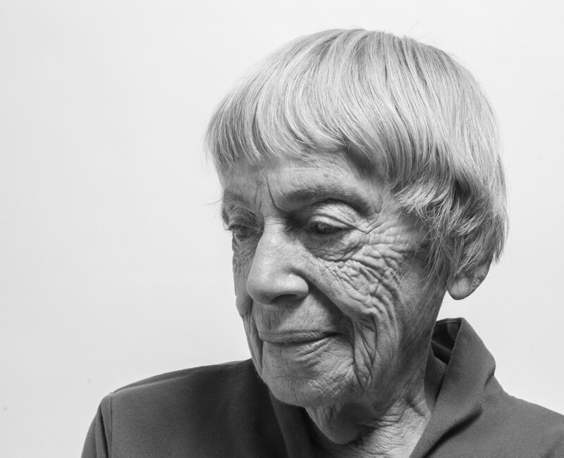 Black and white portrait photo of Ursula K. Le Guin, with pensive smile