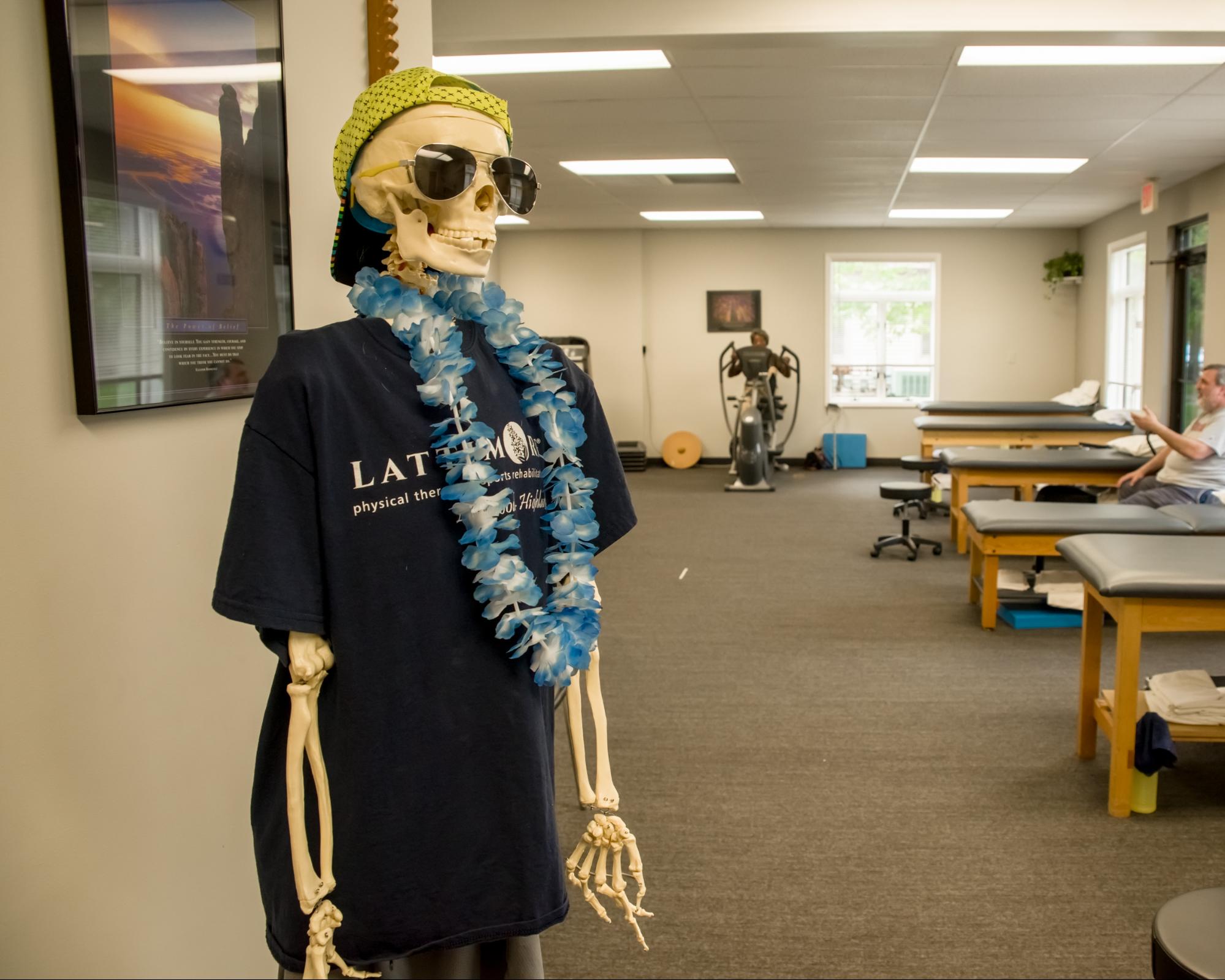 Lattimore Skeleton wearing Lattimore Shirt, lei and hat