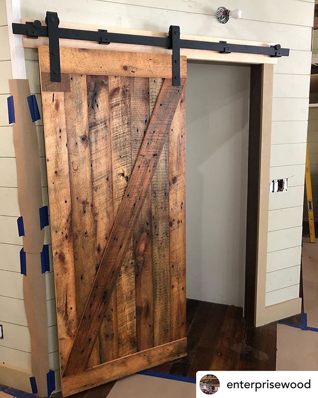 @enterprisewood Reclaimed Pine Barndoor with a custom track from their metal shop. #handcrafted #handcraftingyourvision #enterprisewoodproducts #reclaimedwood