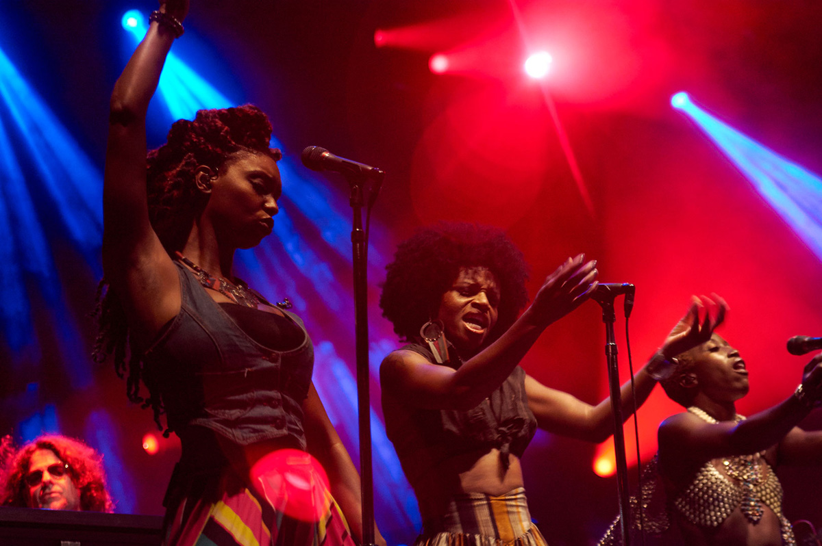 Group of musicians performing on stage with vibrant lighting