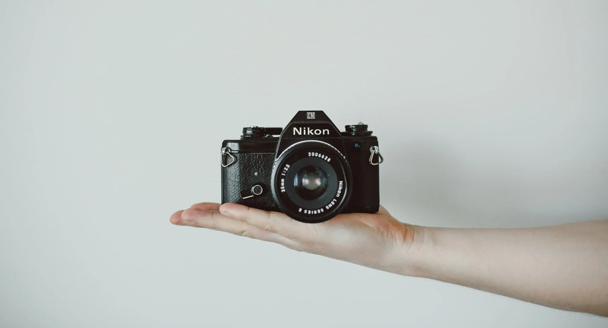 Hand holding a Nikon film camera