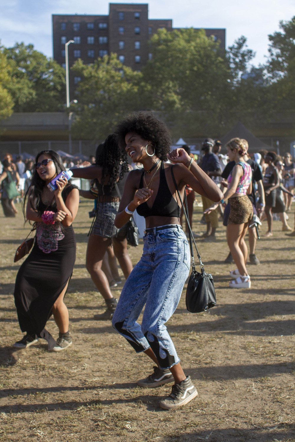 People dancing at an outdoor music festival