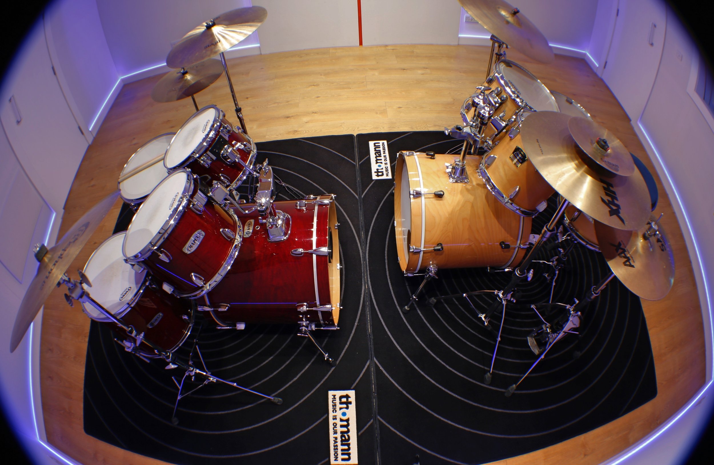 Lesson room where tutor and student play drums together.