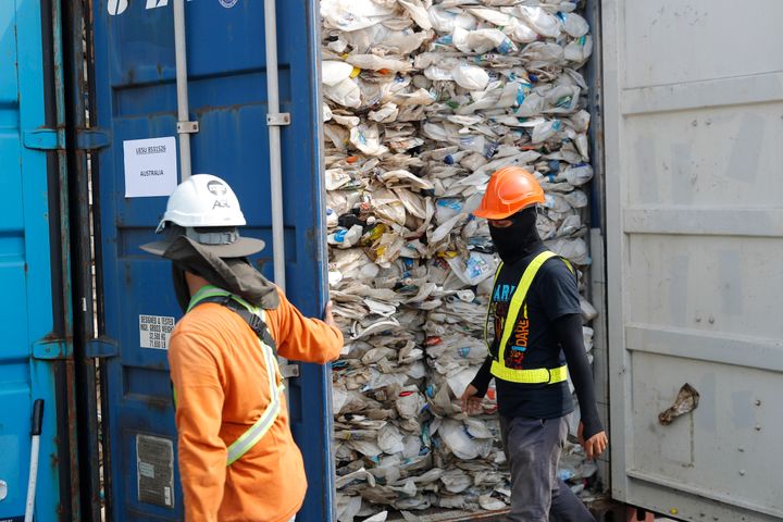ASSOCIATED PRESS Workers open a container full of non-recyclable plastic detained by authorities at the west port in Klang, Malaysia.