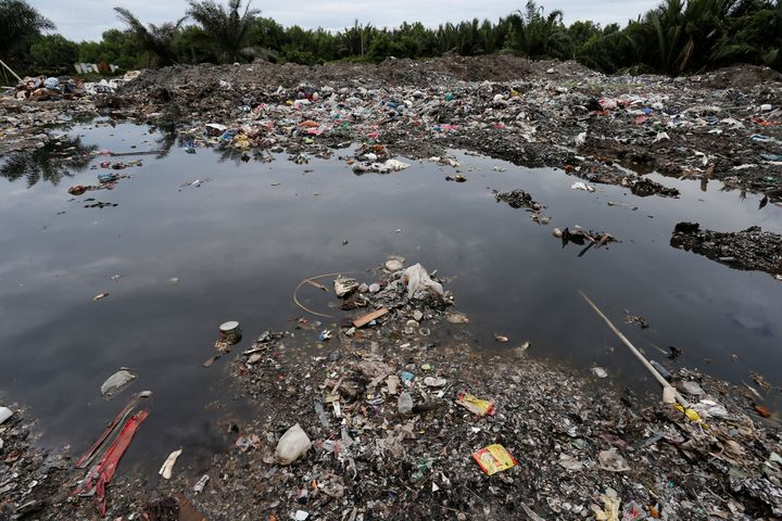 LAI SENG SIN / REUTERS Plastic waste is seen dumped at a palm oil plantation in Telok Panglima Garang, Malaysia in October.