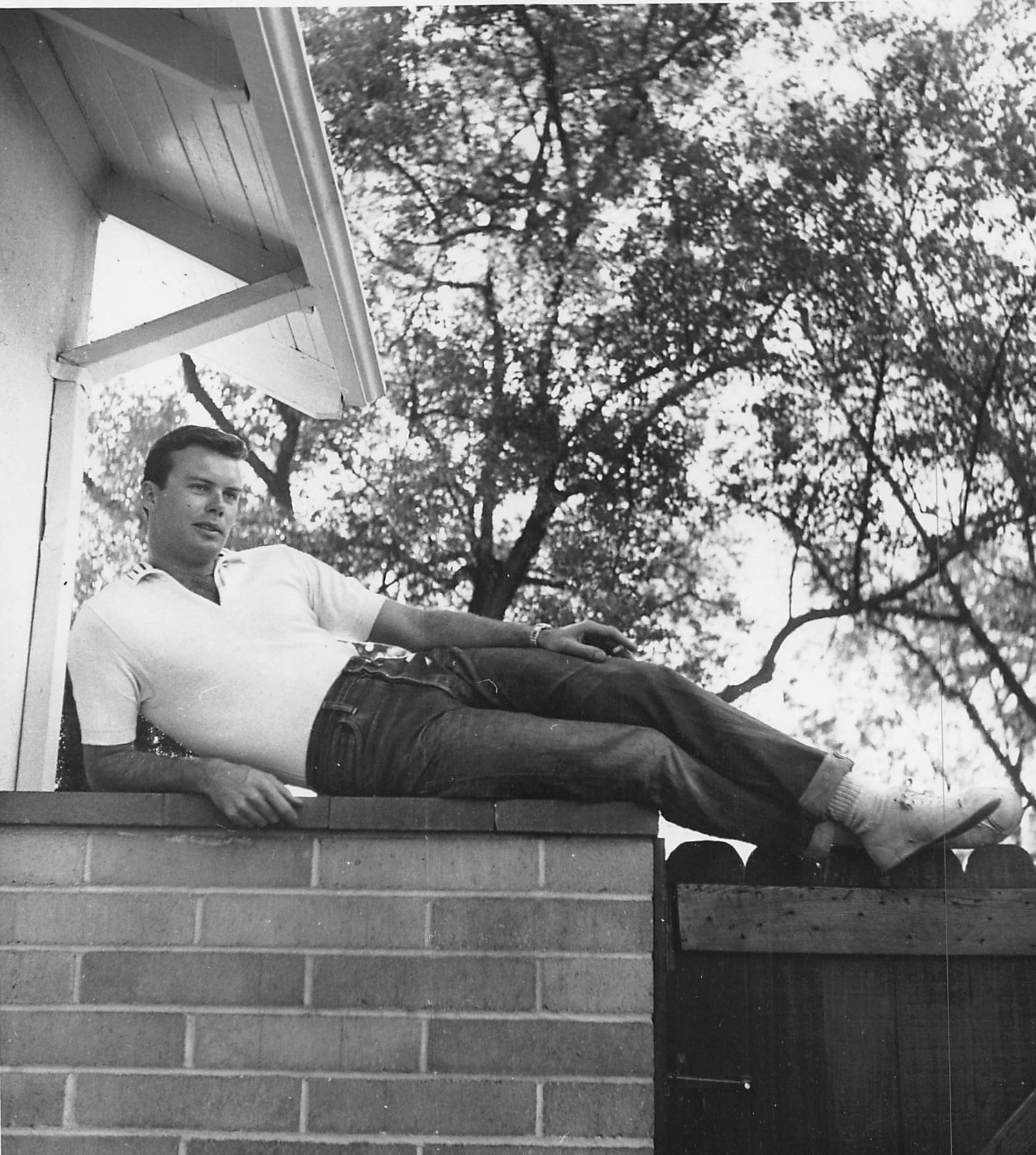  212, c. Jan. 1955. Bob “relaxing" on wall/fence on left side of house leading from front yard to area outside two bedrooms .  Photo: Larry Barberi for Globe Photos, New York City. “Weekend with the Folks”/”A Day to Loaf,”  Screenplay , July 1955. 