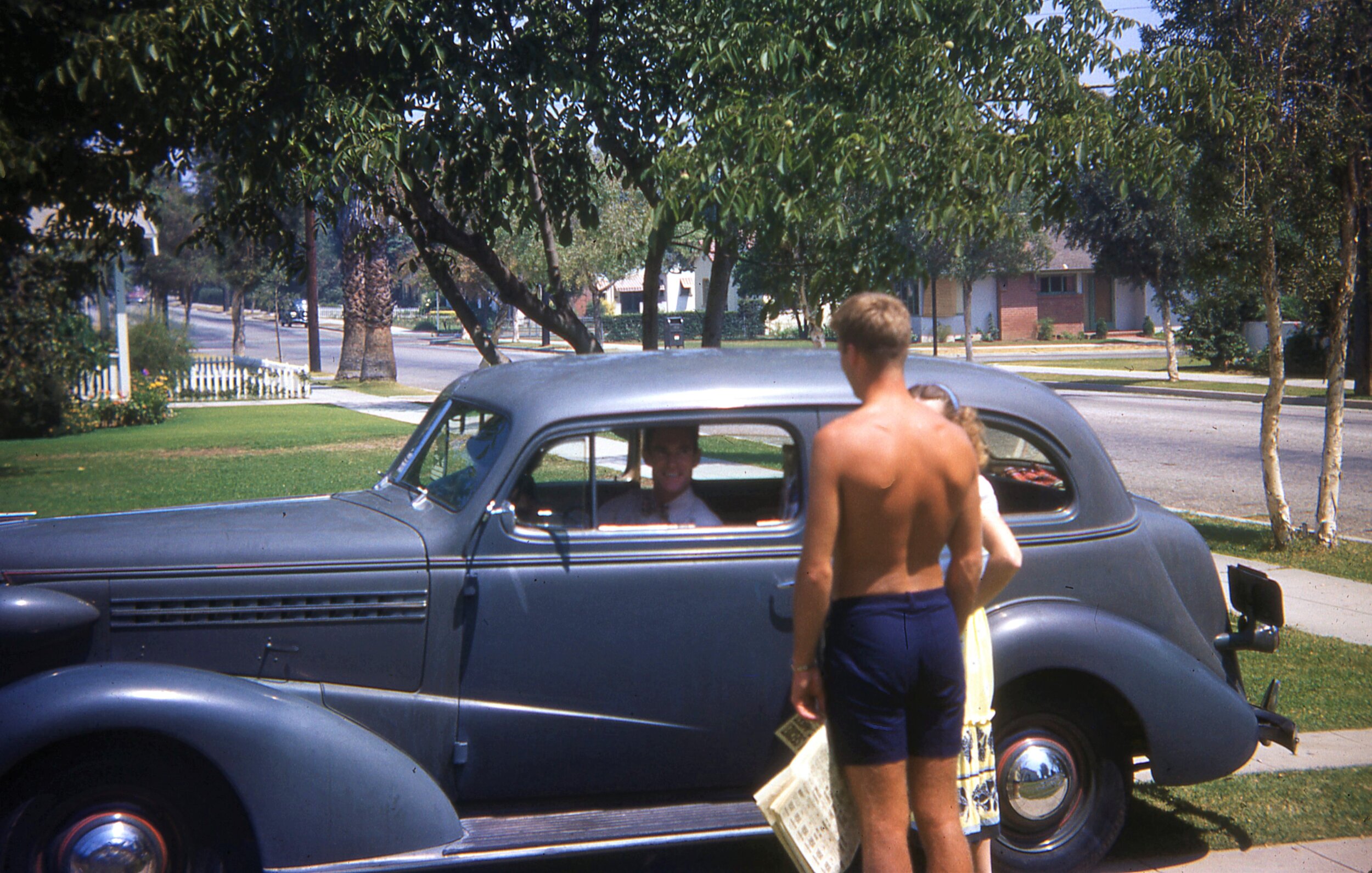  Bob with sister Fran and brother Bill. Backyard of 212. Early 1950s - possibly as early as late 1950. Owner of car unclear, but Bill is in the driver’s seat. Robins Family Collection. 