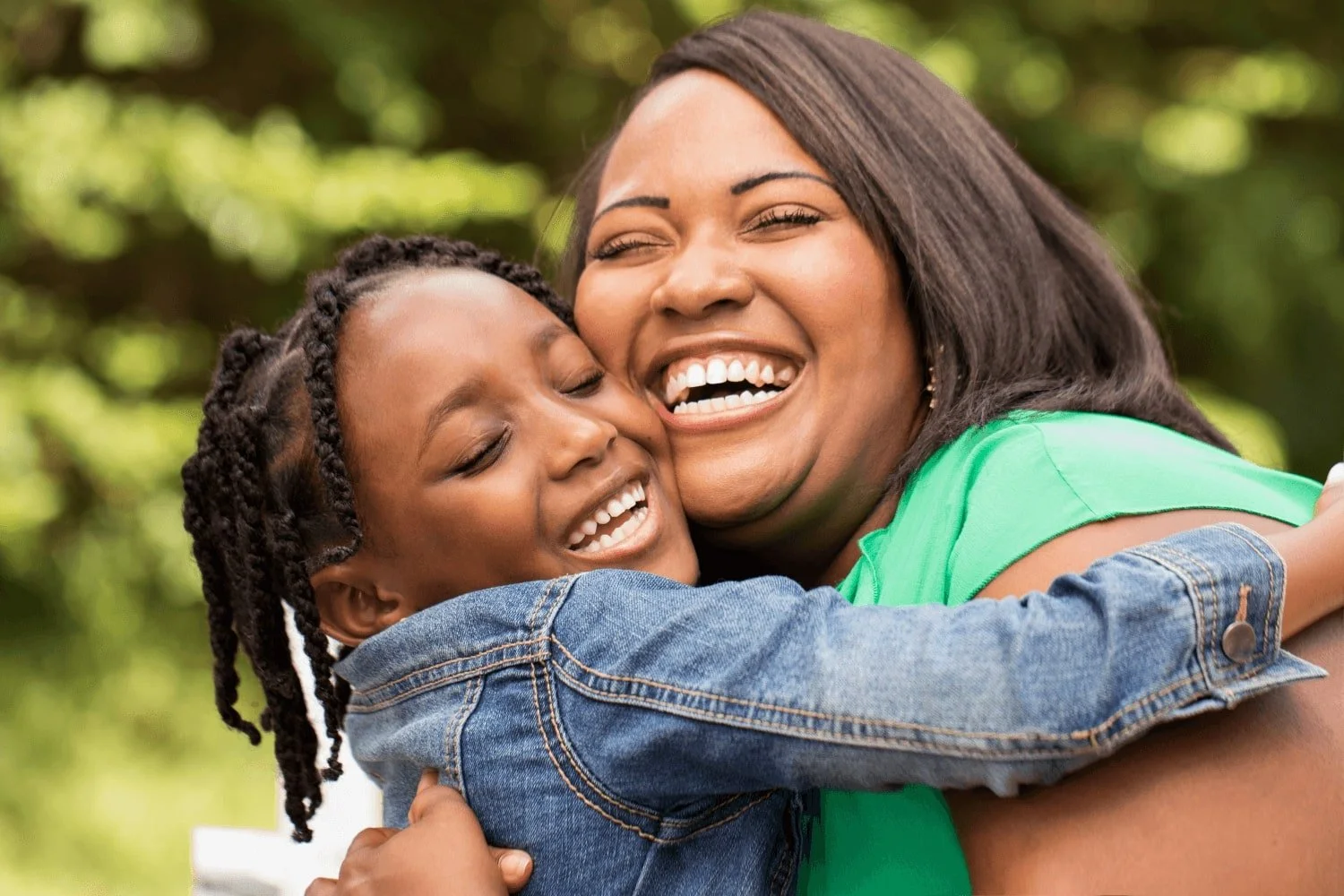 Mother embracing daughter while smiling
