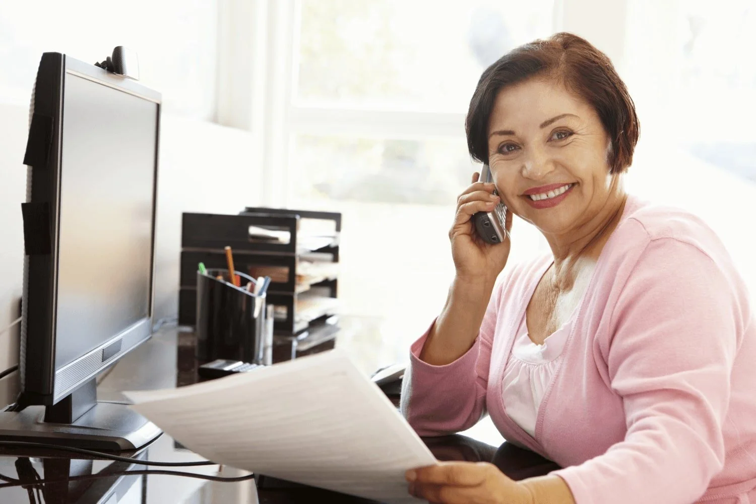 Secretary smiling while at desk