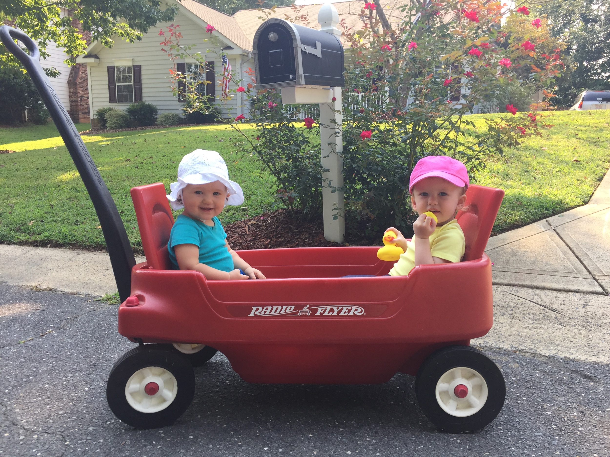 September, 2017: Abby Clare and her bestie Maci Pearl taking a ride on the streets of our old neighborhood, Woodside Falls.