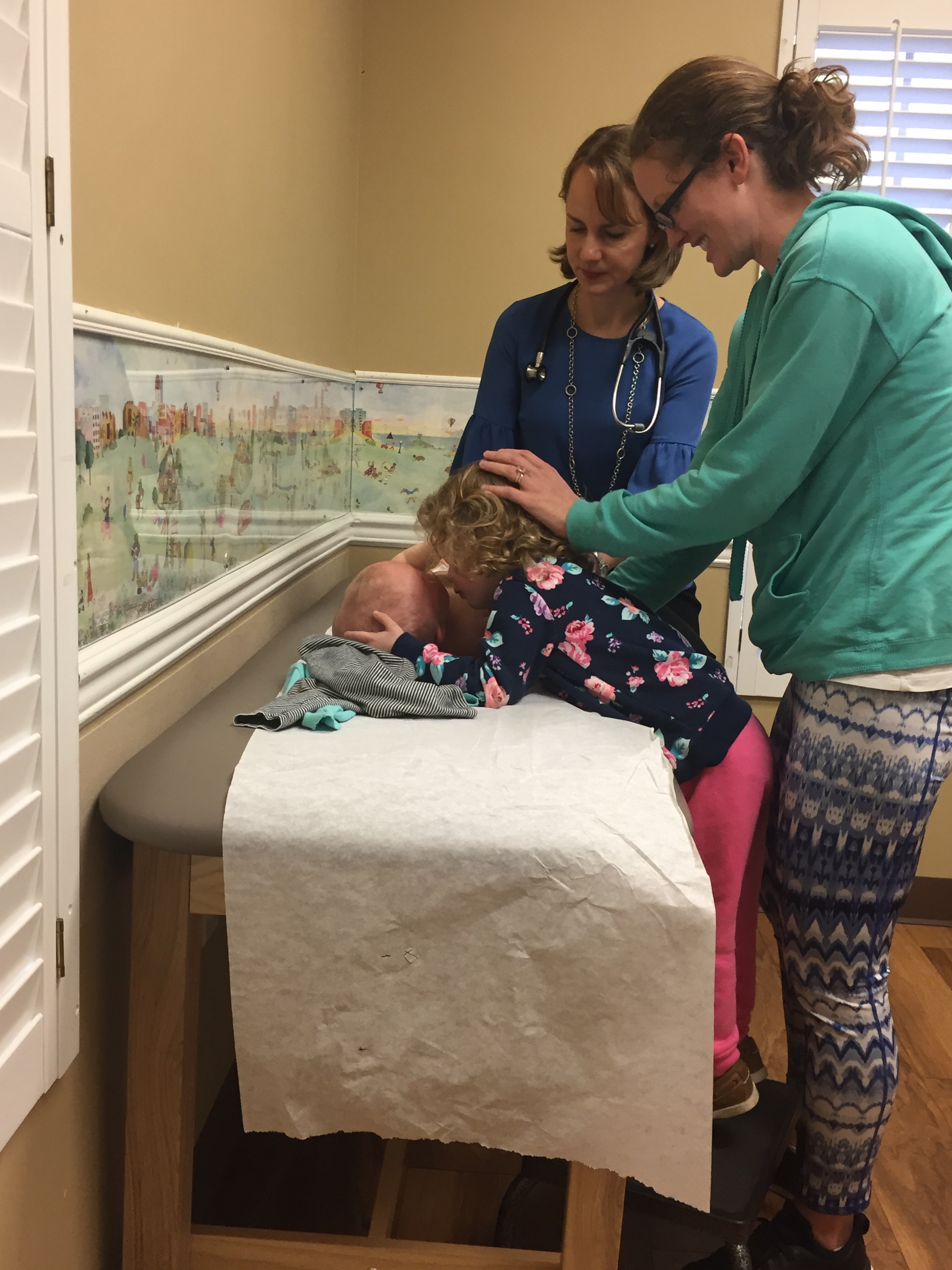 Abby giving her little sister, Hadley, some love during her checkup in Charleston, SC.