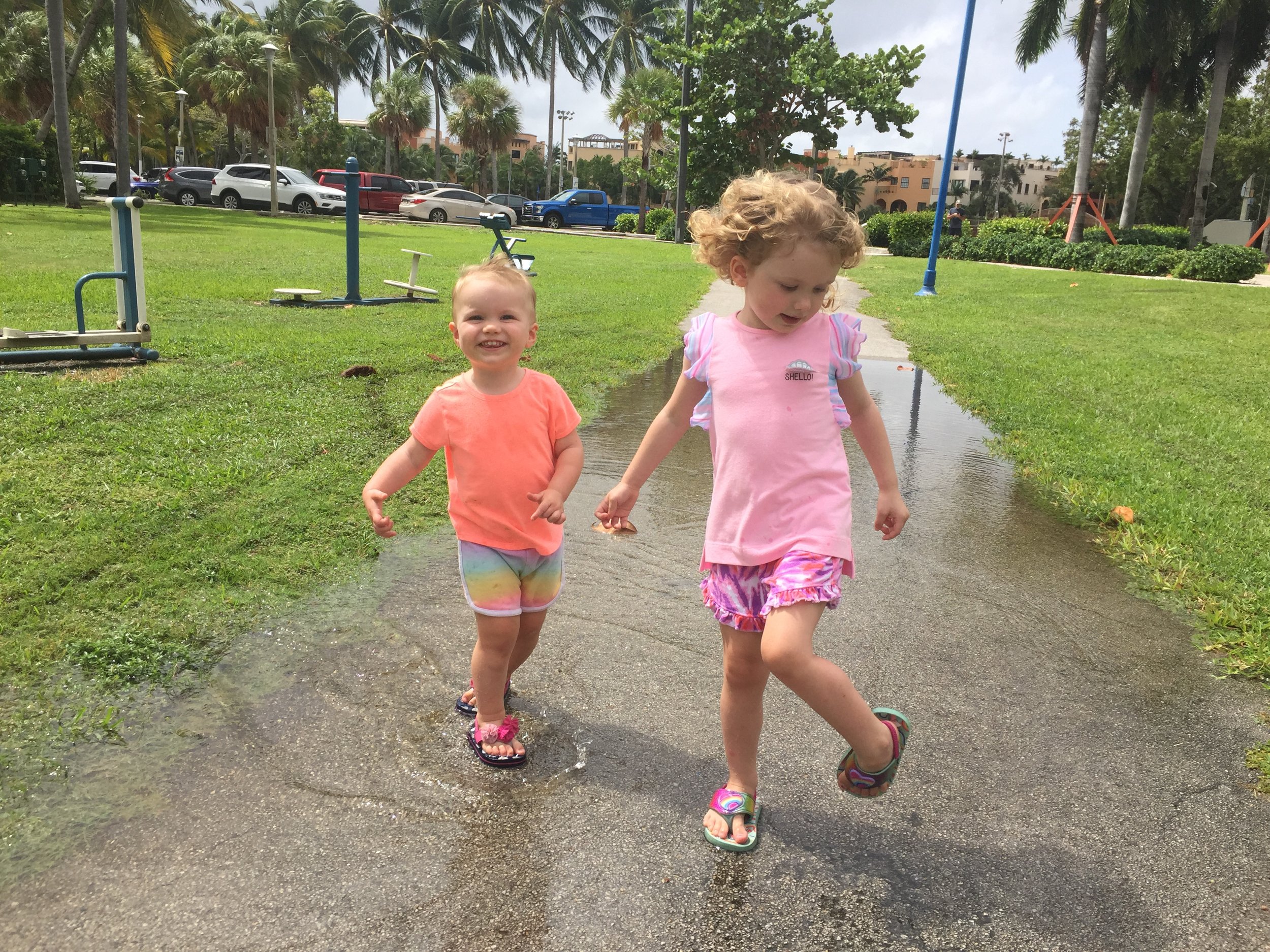 Making the most out of the rainy days; Abby teaching Hadley one of her favorite pastimes, puddle jumping, in Coconut Grove, FL.