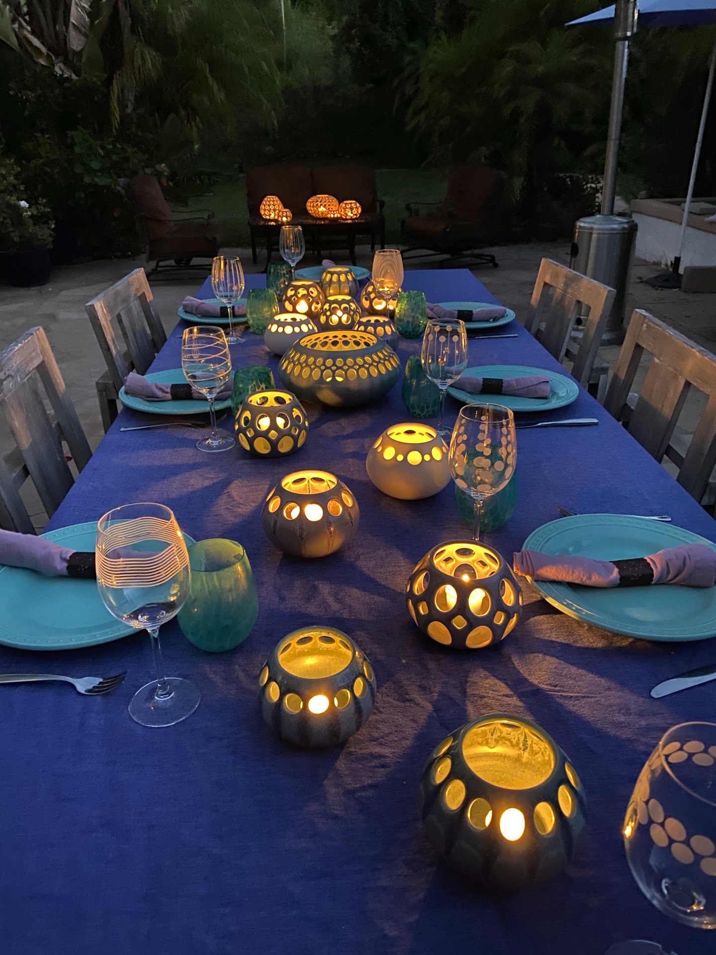 Patio table setting with Lynne Meade tea light holders lit in evening at private residence, Camarillo, CA