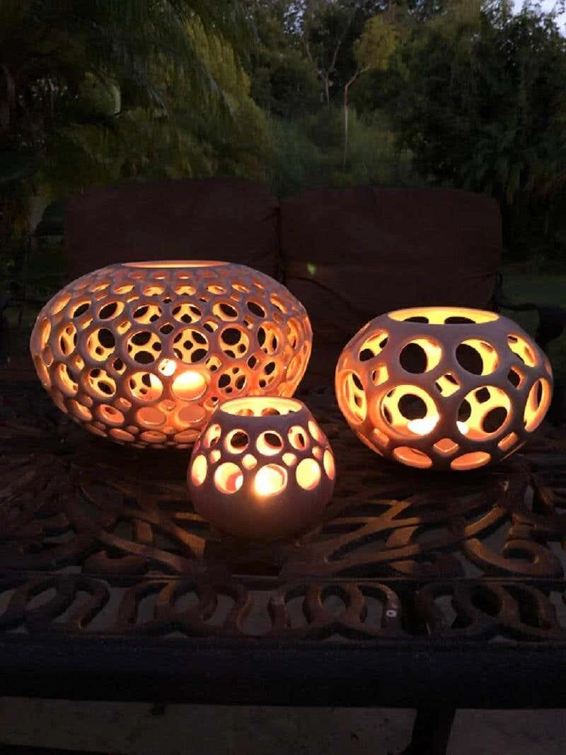 Trio of Lynne Meade Pierced Vessels - Blush lit with candles in evening light on patio table, private residence, CA