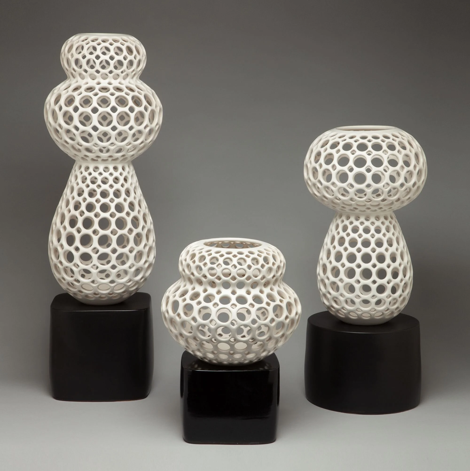 Odette, Babette and Geneva tabletop sculptures in Femme Collection, white on black ceramic stands