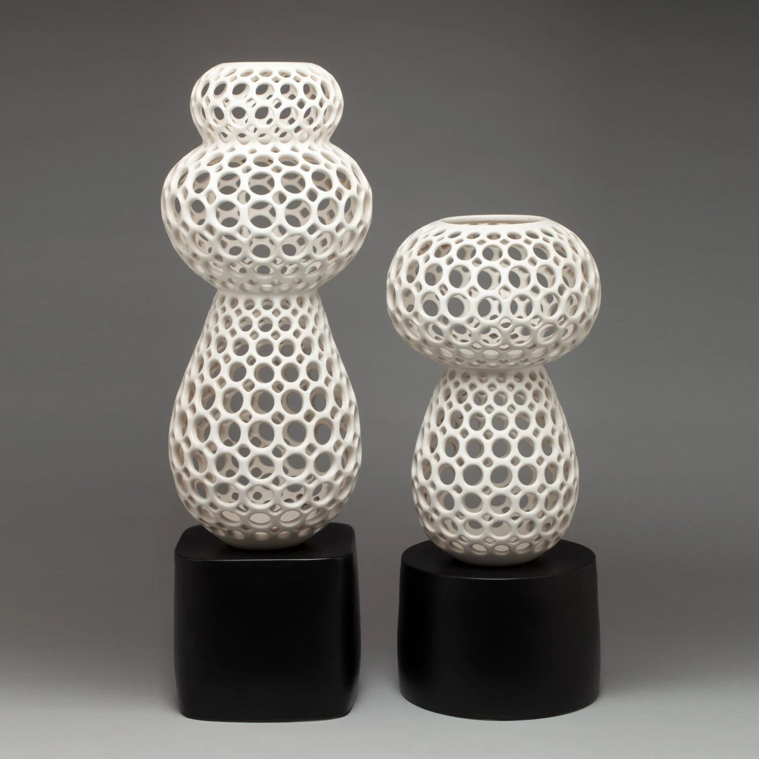 Odette and Geneva table sculptures in Femme Collection in white by Lynne Meade on ceramic black stands