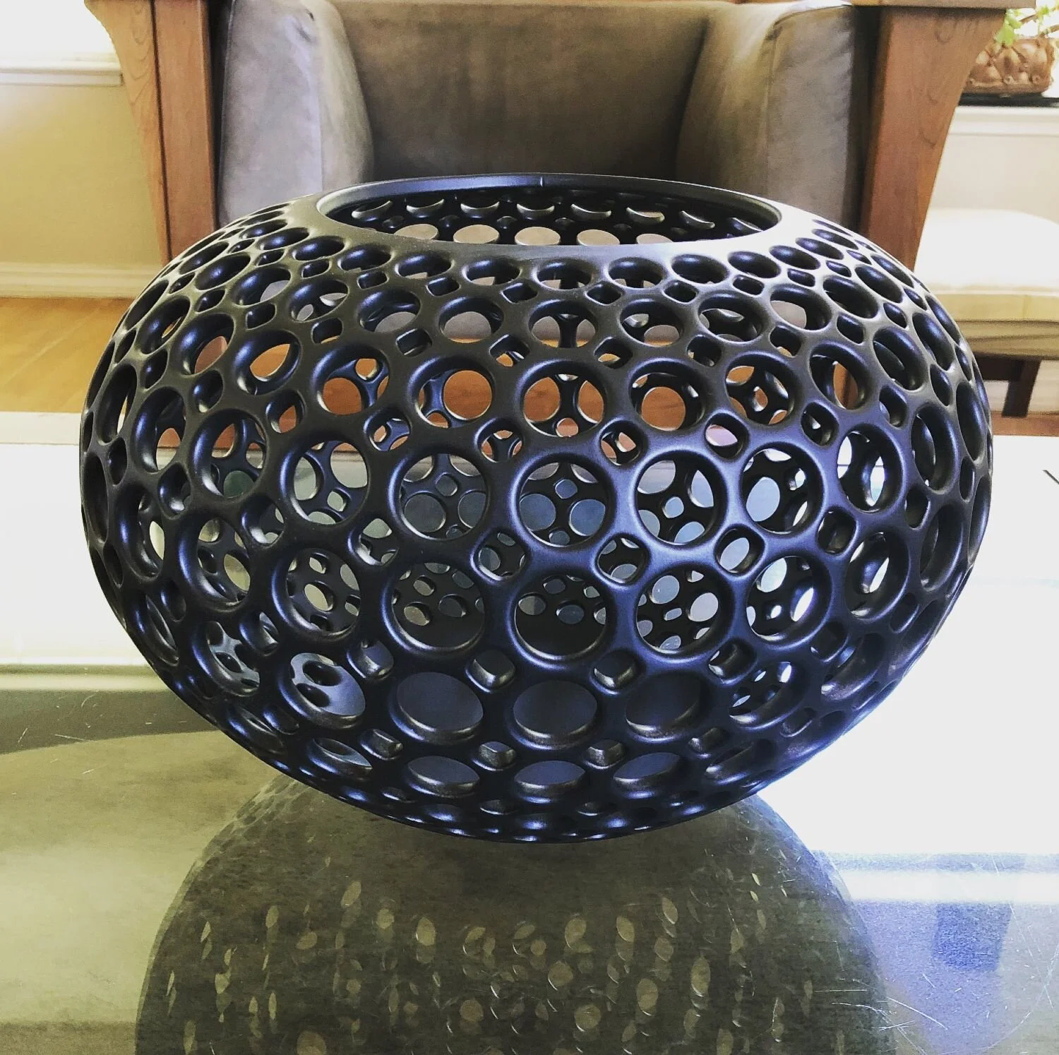 Lace orb vessel in black sitting atop glass table, private residence, Oakland Hills, CA